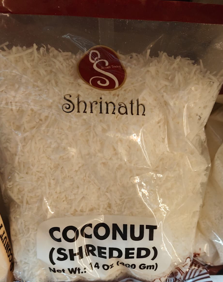 Bag of shredded coconut with 'Shrinath' branding on a shelf.